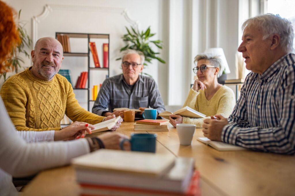 During book club meeting, curious senior people discuss the reference book