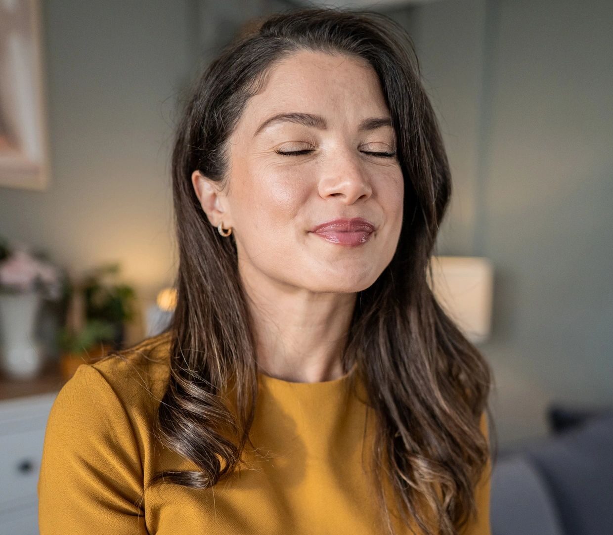 Woman journaling, reflecting on wellbeing and self-care